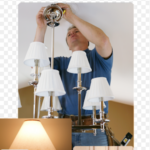 a man wearing a blue shirt repairing a tv lamp