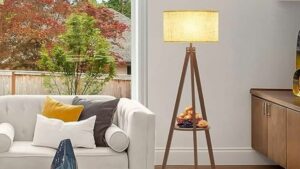 one of the best floor lamps for living rooms and a white sofa with cushions and a background of trees